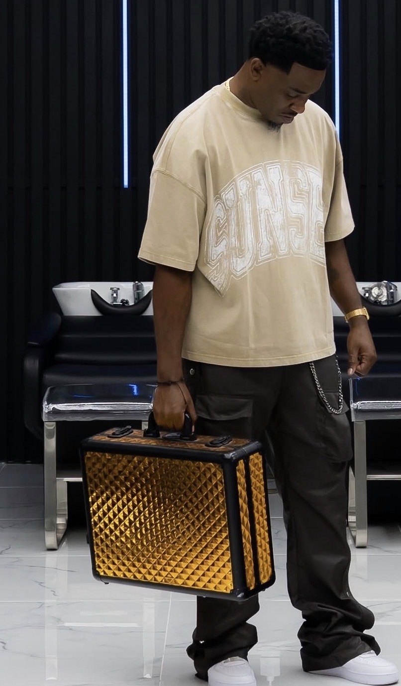 Cory, founder of Creating The Man, holding his signature gold clipper case